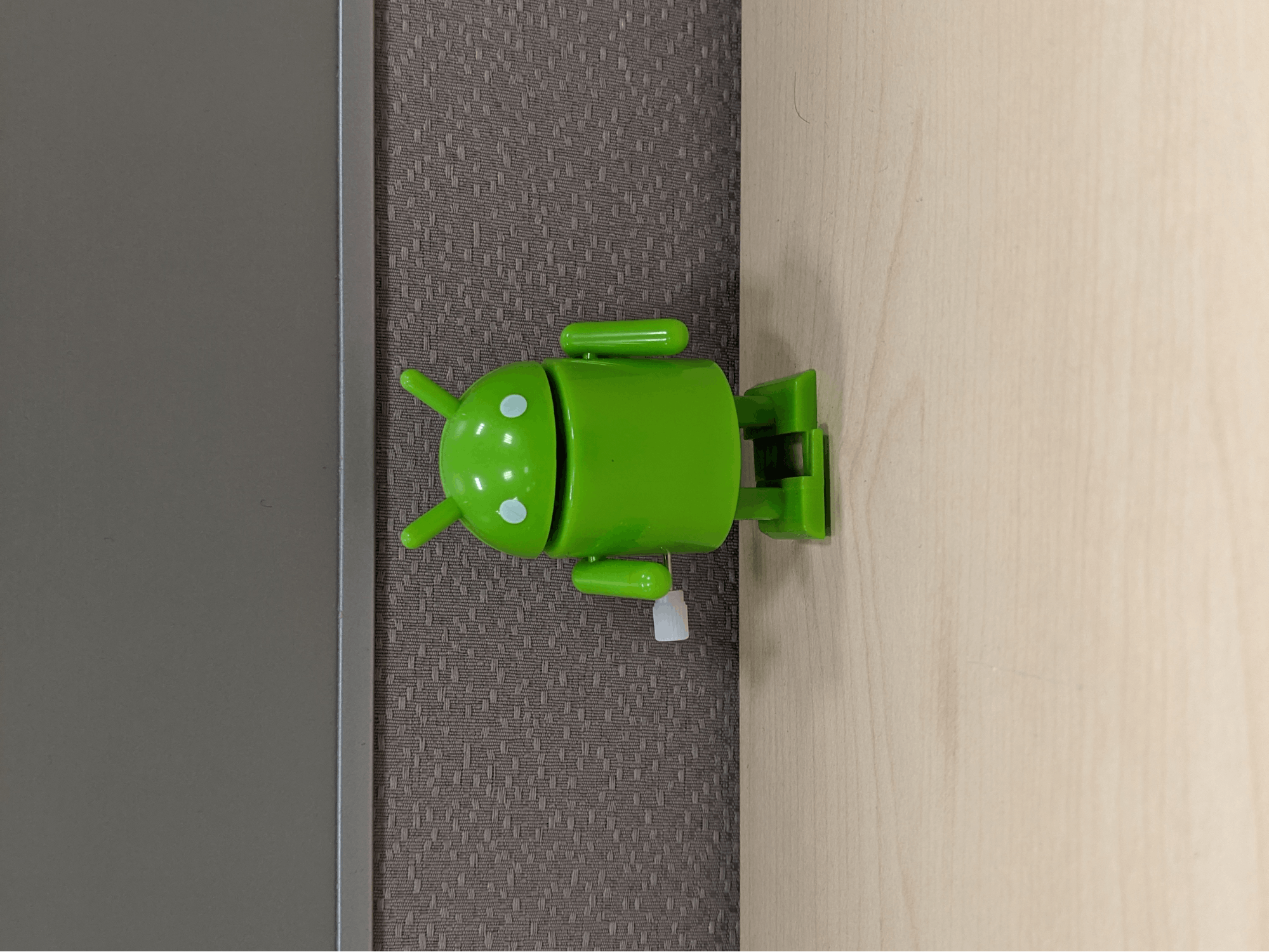 A portrait-shaped image with the bugdroid's head pointed upwards