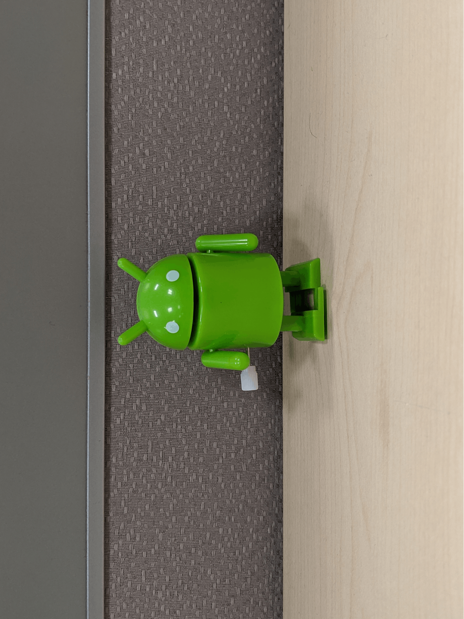 A landscape-shaped image with the bugdroid's head pointed upwards