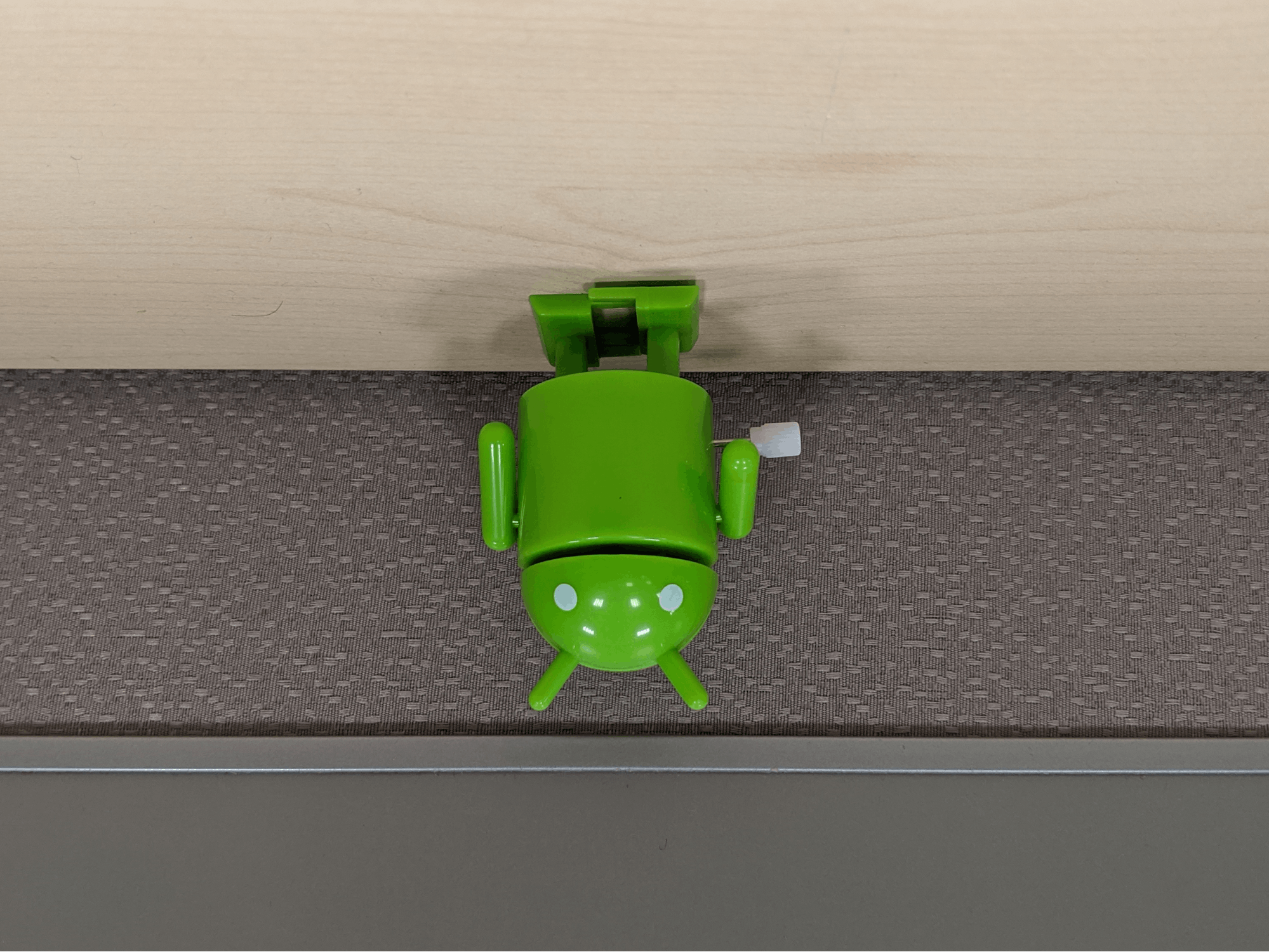 A portrait-shaped image with the bugdroid's head pointed upwards